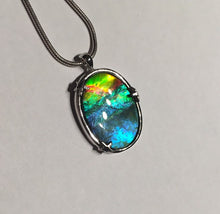 Load image into Gallery viewer, Ammolite pendant in Sterling silver setting with small starfish holding the stone in place. Amazing colour and lustre.
