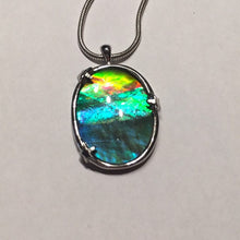 Load image into Gallery viewer, Ammolite pendant in Sterling silver setting with small starfish holding the stone in place. Amazing colour and lustre.