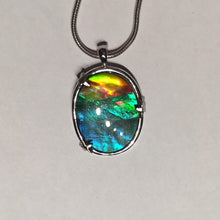 Load image into Gallery viewer, Ammolite pendant in Sterling silver setting with small starfish holding the stone in place. Amazing colour and lustre.