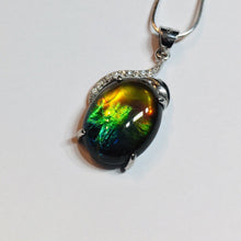 Load image into Gallery viewer, Ammolite pendant in Sterling Silver with Rhodium Plate and Cubic Zirconia. Beautiful rainbow colours and chromatic shift.
