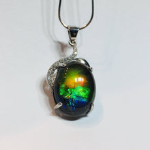 Load image into Gallery viewer, Ammolite pendant in Sterling Silver with Rhodium Plate and Cubic Zirconia. Beautiful rainbow colours and chromatic shift.