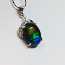 Load image into Gallery viewer, Ammolite pendant in Sterling Silver with Rhodium Plate and Cubic Zirconia. Beautiful rainbow colours and chromatic shift.