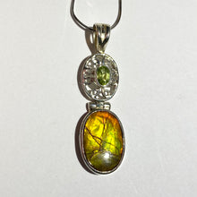 Load image into Gallery viewer, Ammolite pendant in Sterling Silver with Peridot.   Shifting colours, yellow, green, orange sparkle.