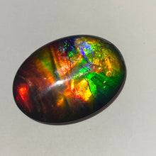 Load image into Gallery viewer, AAA+ ammolite calibrated cabochon. Beautiful rainbow colours. 40x30 mm low dome quartz cap