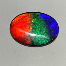 Load image into Gallery viewer, AAA+ ammolite calibrated cabochon. Beautiful red, sparkling aqua and blue colours. 25x18 mm low dome quartz cap