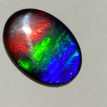 Load image into Gallery viewer, AAA+ ammolite calibrated cabochon. Beautiful flash red, green and blue colours. 25x18 mm low dome quartz cap
