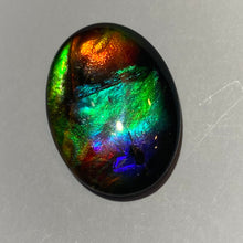 Load image into Gallery viewer, AAA+ ammolite calibrated cabochon. Exceptional colours and depth in this beautiful stone with pink and purple. 25x18 mm low dome quartz cap