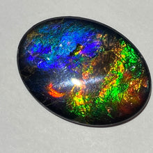 Load image into Gallery viewer, AAA+ ammolite calibrated cabochon. Beautiful pink spots and rainbows. 30x22 mm low dome quartz cap