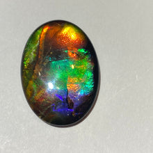 Load image into Gallery viewer, AAA+ ammolite calibrated cabochon. Exceptional colours and depth in this beautiful stone with pink and purple. 25x18 mm low dome quartz cap
