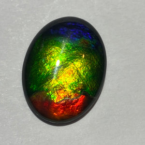 AAA ammolite calibrated cabochon. Beautiful red green and blue colours 20x15 mm high dome quartz cap