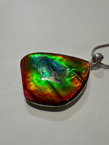 Beautiful ammolite necklace set in silver, featuring vibrant reds, yellows and blues