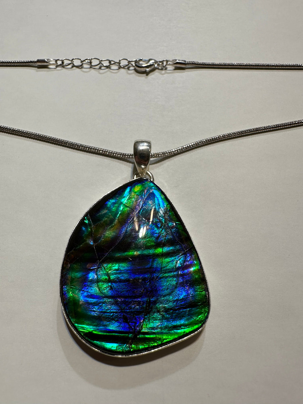 Beautiful ammolite necklace set in silver, featuring vibrant blues and greens