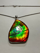 Load image into Gallery viewer, Beautiful ammolite necklace set in silver, featuring vibrant reds, yellows and blues
