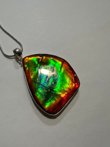 Beautiful ammolite necklace set in silver, featuring vibrant reds, yellows and blues