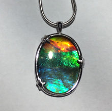 Load image into Gallery viewer, Ammolite pendant in Sterling silver setting with small starfish holding the stone in place. Amazing colour and lustre.
