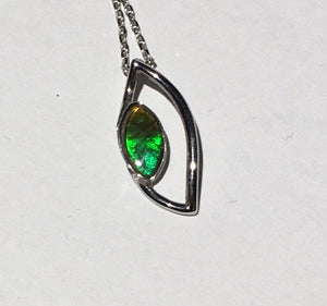 Bright little Ammolite pendant in Sterling silver. Unique dragon eye design, beautiful gem.