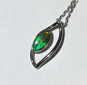 Bright little Ammolite pendant in Sterling silver. Unique dragon eye design, beautiful gem.