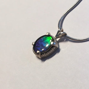 Ammolite pendant In Sterling Silver with beautiful lustre and vibrant colours of the rainbow.