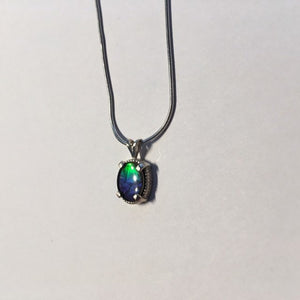 Ammolite pendant In Sterling Silver with beautiful lustre and vibrant colours of the rainbow.