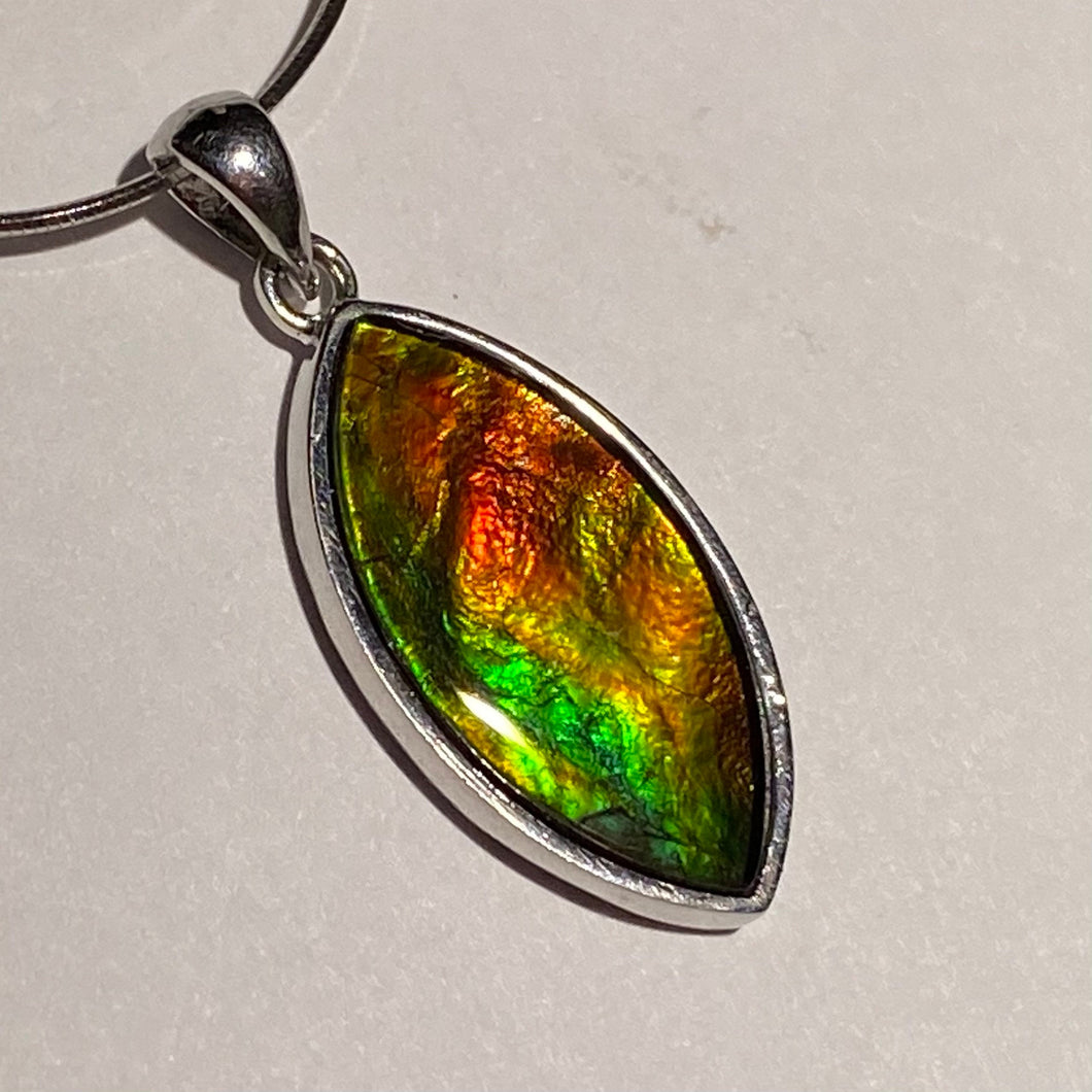 Ammolite pendant in Sterling Silver with vibrant red green and gold