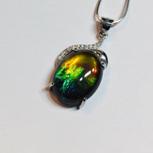 Load image into Gallery viewer, Ammolite pendant in Sterling Silver with Rhodium Plate and Cubic Zirconia. Beautiful rainbow colours and chromatic shift.
