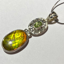 Load image into Gallery viewer, Ammolite pendant in Sterling Silver with Peridot.   Shifting colours, yellow, green, orange sparkle.
