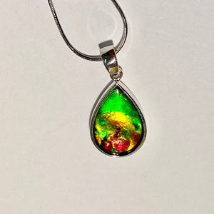 Ammolite pendant, vibrant green, yellow and red in sterling silver setting