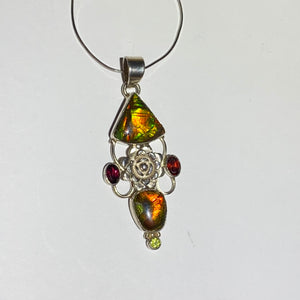 Ammolite pendant Sterling Silver with garnet and peridot really pretty with little flowers in the setting!