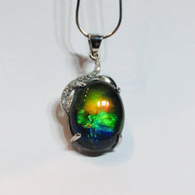 Load image into Gallery viewer, Ammolite pendant in Sterling Silver with Rhodium Plate and Cubic Zirconia. Beautiful rainbow colours and chromatic shift.
