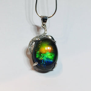 Ammolite pendant in Sterling Silver with Rhodium Plate and Cubic Zirconia. Beautiful rainbow colours and chromatic shift.