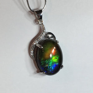 Ammolite pendant in Sterling Silver with Rhodium Plate and Cubic Zirconia. Beautiful rainbow colours and chromatic shift.