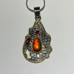 Ammolite pendant with black rhodium and gold plate with ruby