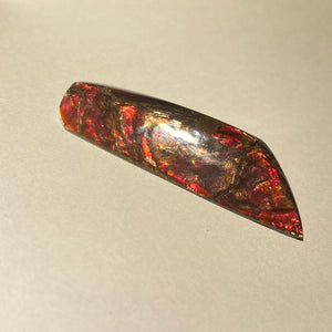 Pearlescent glowing red ammolite free form 37x20x10 mm