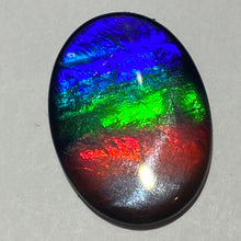 Load image into Gallery viewer, AAA+ ammolite calibrated cabochon. Beautiful flash red, green and blue colours. 25x19 mm low dome quartz cap
