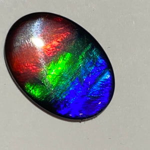 AAA+ ammolite calibrated cabochon. Beautiful flash red, green and blue colours. 25x18 mm low dome quartz cap