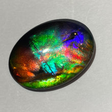 Load image into Gallery viewer, AAA+ ammolite calibrated cabochon. Exceptional colours and depth in this beautiful stone with pink and purple. 25x18 mm low dome quartz cap
