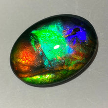 Load image into Gallery viewer, AAA+ ammolite calibrated cabochon. Exceptional colours and depth in this beautiful stone with pink and purple. 25x18 mm low dome quartz cap
