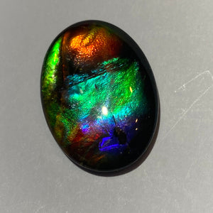 AAA+ ammolite calibrated cabochon. Exceptional colours and depth in this beautiful stone with pink and purple. 25x18 mm low dome quartz cap
